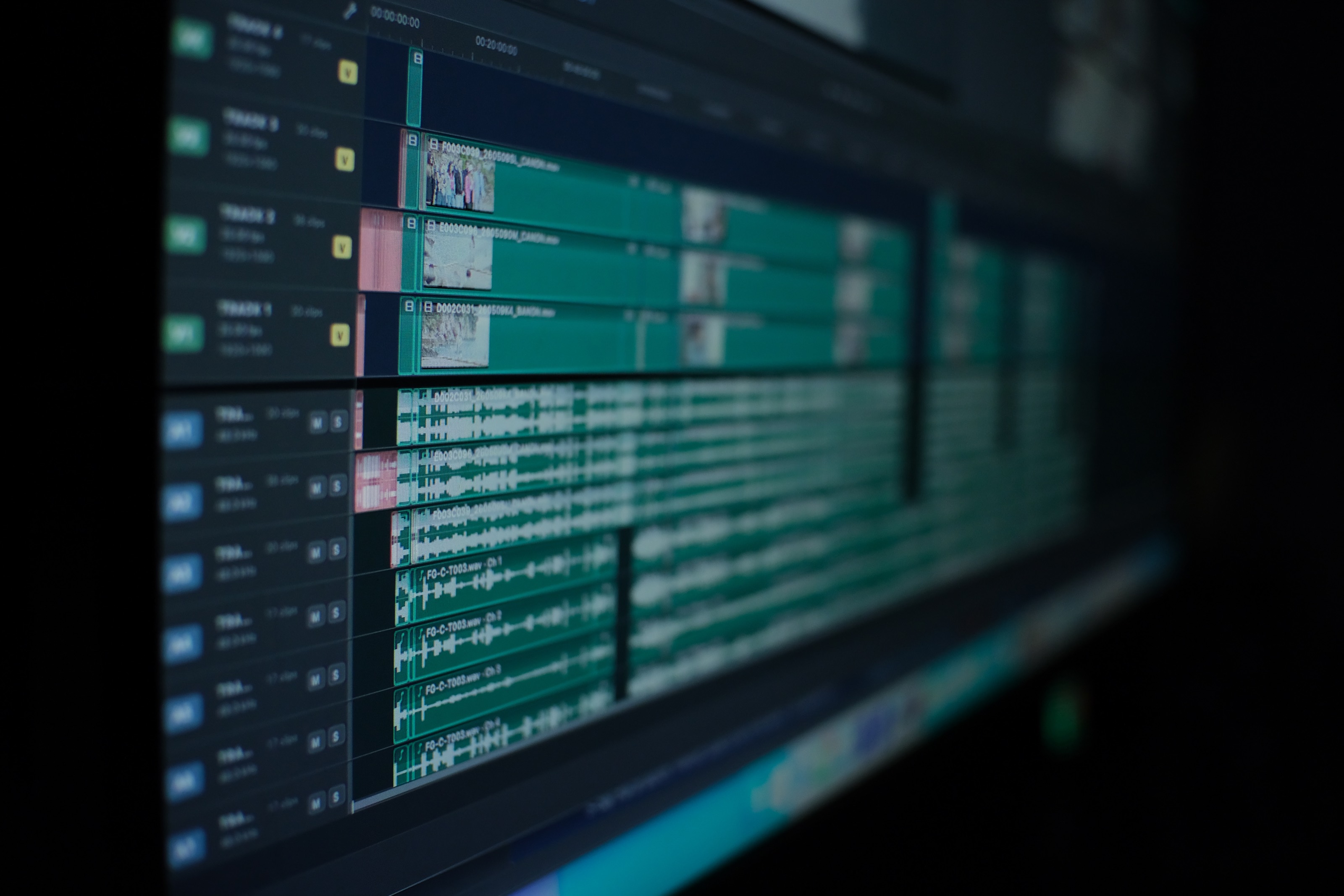 Synced timeline with four camera tracks above multichannel audio tracks